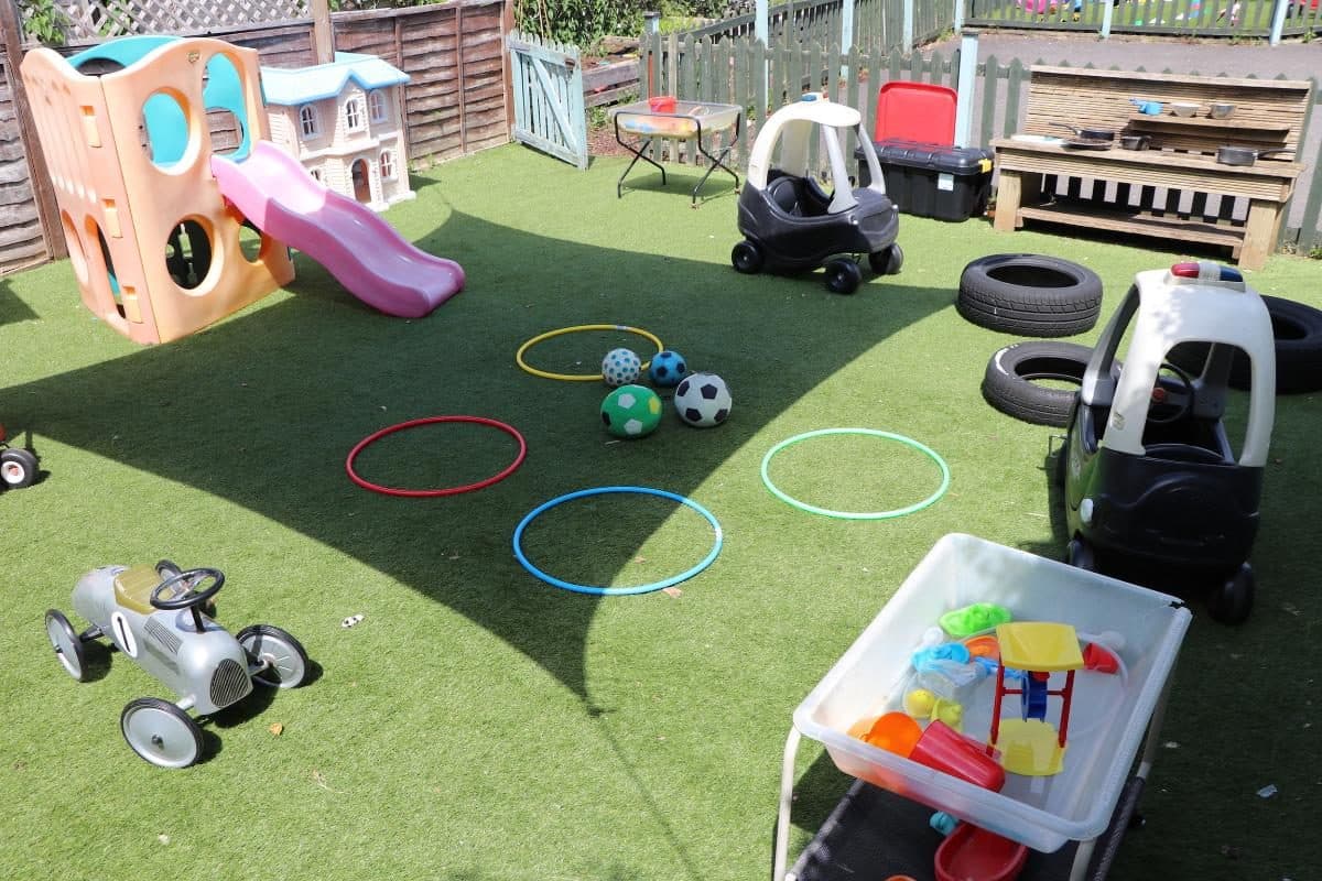 Outdoor activity area with coloured hoops and balls at Hazlemere nursery